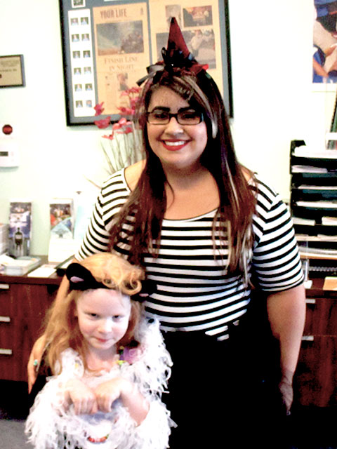 Nancy dressed as a witch and a child dressed as a cat.